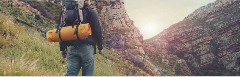 Adventurer hiking through the Isle of Skye Mountain Ranges