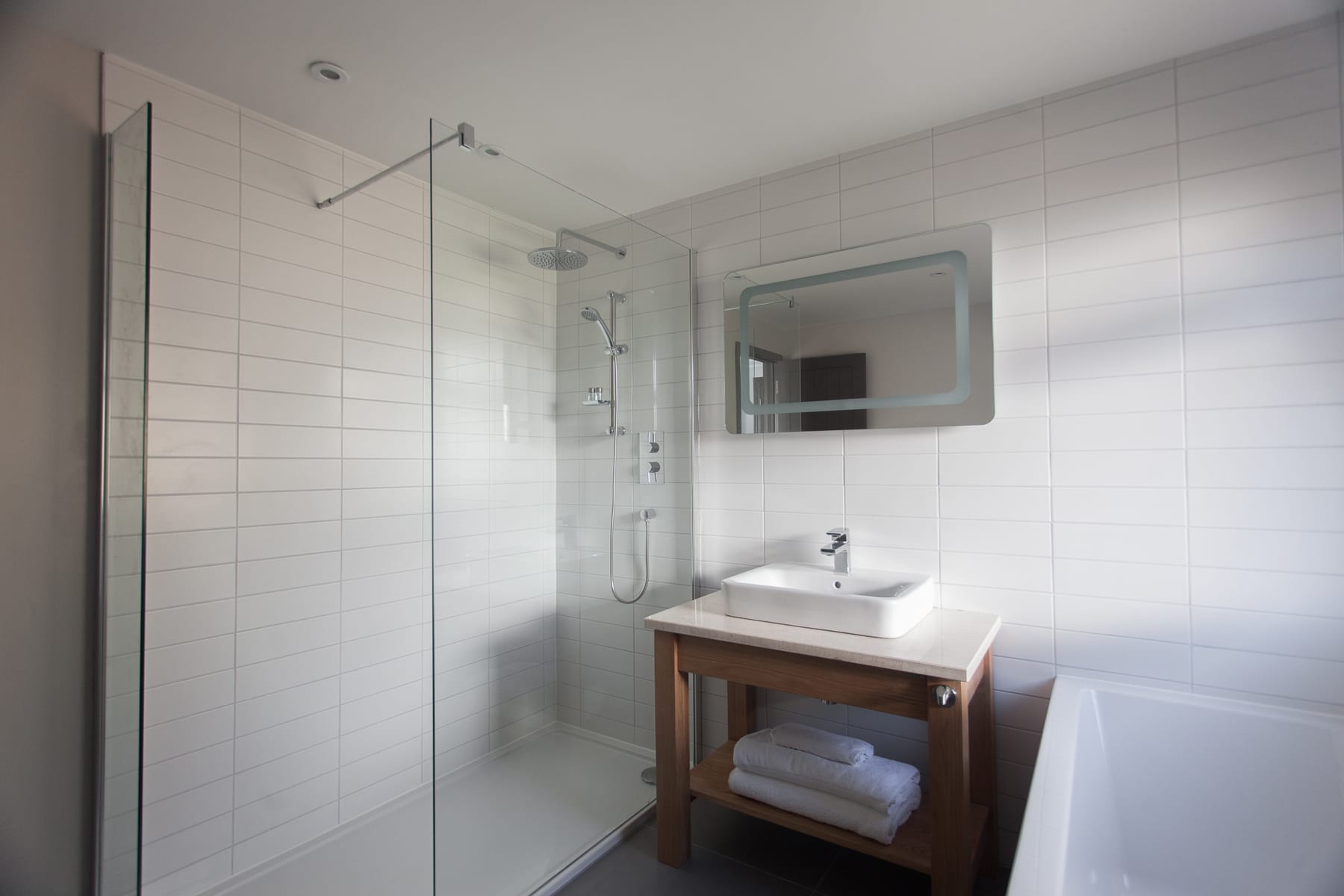 large bathroom with bath and separate shower at The Bosville Hotel